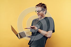 Astonished Man in Glasses Looking at Laptop Screen