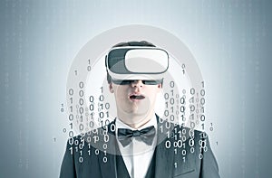 Astonished man in VR glasses, zeros and ones