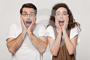 Astonished millennial guy and woman winners amazed by unbelievable news.