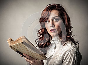 Astonished woman with a book