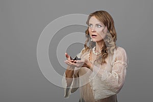 Astonished woman with candle in hand