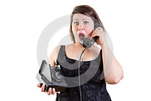 Astonished woman talking on a telephone