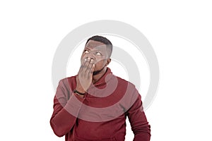 Astonished young man covering mouth with hand
