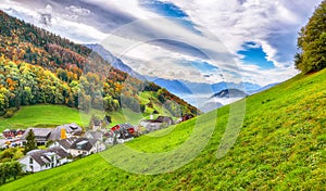 Astonishing autumn view on suburb of Hergiswil village with mountaines and fog