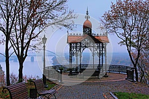 Astonishing landscape of panoramic viewing platform with beautiful arbor in foggy autumn morning in the Saint Volodymyr Hill.