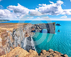 Astonishing landscape with unique basalt arch on Dyrholaey Nature Reserve on Atlantic South Coast