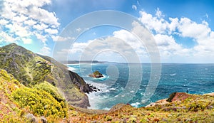 Astonishing spring view of Nebida and Fontanamare coastline with Scoglio il Morto and turquoise sea