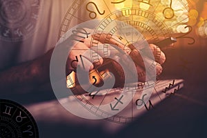 Astrologer using mobile smart phone app and computer to make predictions on future outcome