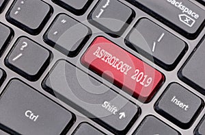Astrology 2019 red on enter key, of a black keyboard.