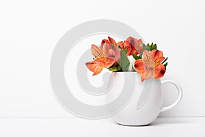 Astromeria flower in tea coffee white mug cup. Mockup concept with plant buds. Studio shot with copy space