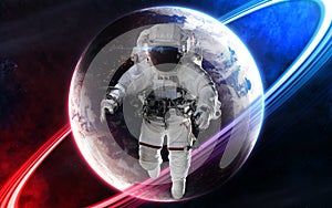 Astronaut on background of deep space planet in light of red and blue star