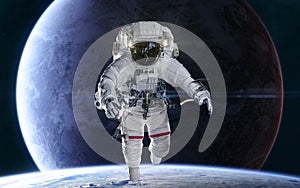 Astronaut on background of distant planets in deep space. Science fiction