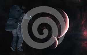 Astronaut on background of inhabited planets in red light. Deep space