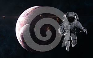 Astronaut on background of inhabited planets in red light. Deep space