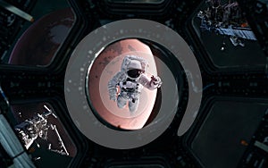 Astronaut on background of Mars. Solar system. View from porthole of spaceship. 3D Render. Science fiction