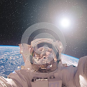 Astronaut and earth from space with a dramatic view. The elements of this image furnished by NASA