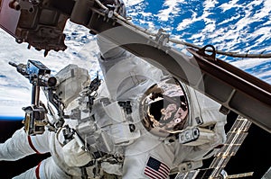 Astronaut float in the space in weightlessness working on the spaceship near to planet earth