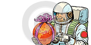 Astronaut gives the planet Mars. Isolate on white background