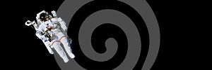 Astronaut with a jetpack isolated on black panoramic background with copy space photo