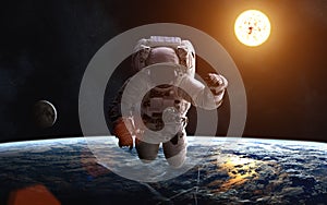 Astronaut. Landscape of Earth. Sun. Moon. Solar System. Elements of the image are furnished by NASA