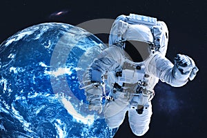 Astronaut near night Earth planet in outer space
