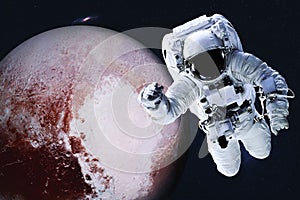 Astronaut near Planet Pluto in colour in space