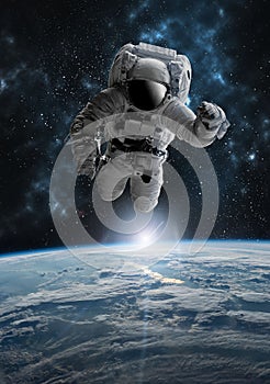Astronaut in outer open space over the planet Earth.Stars provide the background.erforming a space above planet Earth.Sunrise,