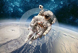 Astronaut in outer space against the backdrop of the planet eart