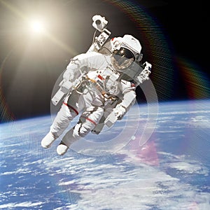 Astronaut in outer space on background of the Earth.