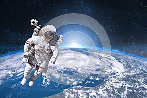 Astronaut in outer space on background of the Earth.