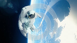 Astronaut in outer space is flying over the Earth