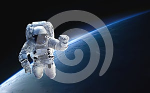 Astronaut in outer space on orbit of the planet Earth.