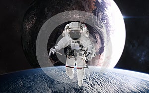 Astronaut in outer space in planetary orbit. Inhabited planet in deep space