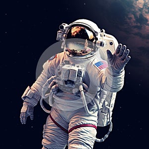 Astronaut in outer space waving his hand to the camera.