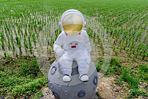Astronaut sculpture on the field.