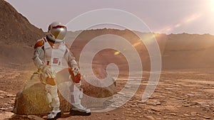 Astronaut sitting on Mars and admiring the scenery. Exploring Mission To Mars. Futuristic Colonization and Space Exploration