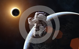 Astronaut. Solar eclipse. Moon and Earth