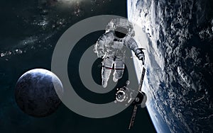 Astronaut, space station, planets in deep space against backdrop of spiral galaxy