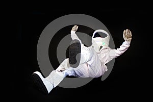 Astronaut in space, in zero gravity on black background.