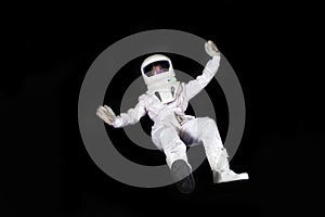 Astronaut in space, in zero gravity on black background. Man in space, falling