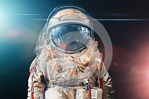 Astronaut or spaceman or cosmonaut on dark space background with blue and red light as sci-fi or fantastic explore background