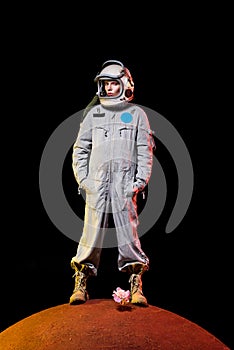 astronaut in spacesuit and helmet standing on peony