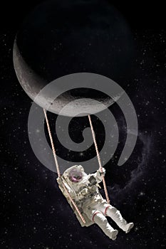 Astronaut swings on a rope swing attached to the moon