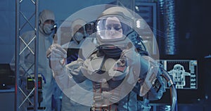 Astronaut testing spacesuit in laboratory