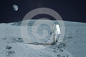 Astronaut is walking on the moon. With land on the horizon. Elements of this image were furnished by NASA