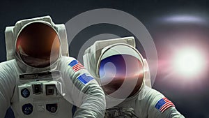 Astronauts in space suits and reflective helmets fly in outer space against the backdrop of the sun and twinkling stars.