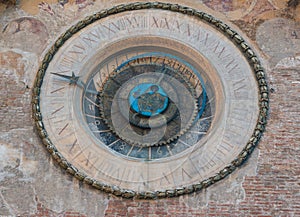 Astronomical clock with roman numerals and zodiac signs on the Torre dell'Orologio tower in Mantua