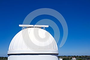 Astronomical observatory dome in blue sky