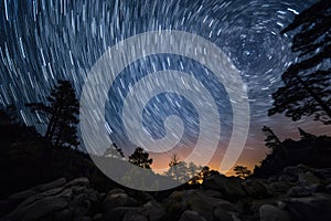 astrophotographer captures starry night sky above beach with misty waves rolling in