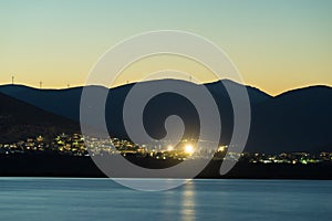 Astros town at night Greece, wind turbines on hills photo